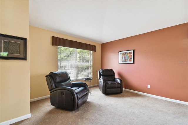 sitting room featuring lofted ceiling and light colored carpet