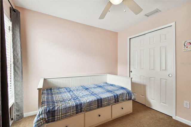 bedroom with light carpet, a closet, and ceiling fan