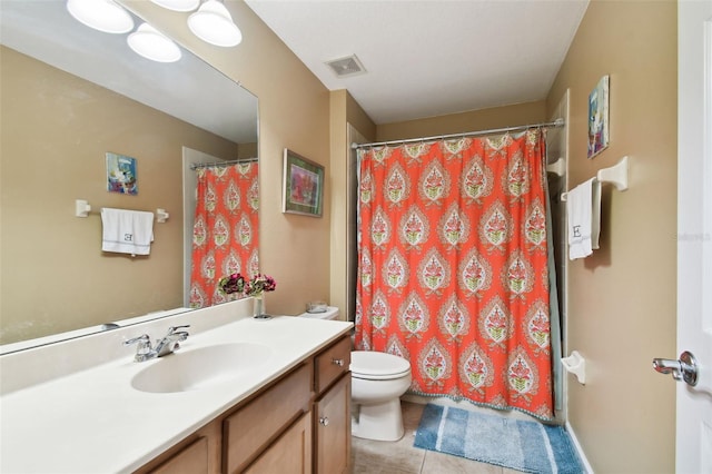 bathroom featuring vanity, walk in shower, tile patterned floors, and toilet