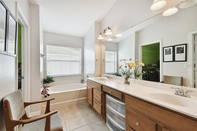 bathroom with tile patterned flooring, vanity, and a tub to relax in