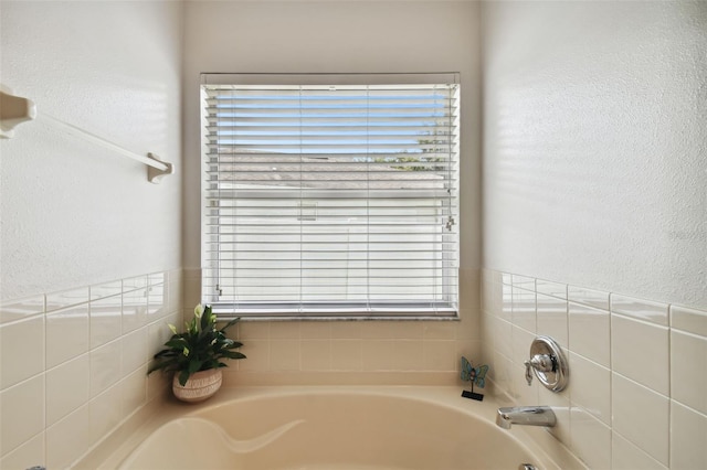 bathroom featuring plenty of natural light and a bathtub