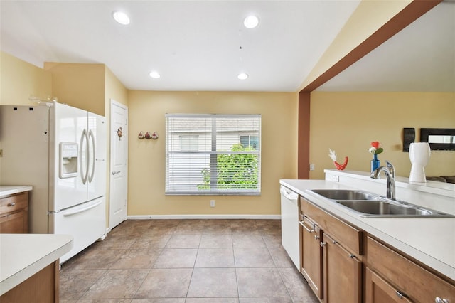 kitchen featuring light tile patterned flooring, sink, and white appliances