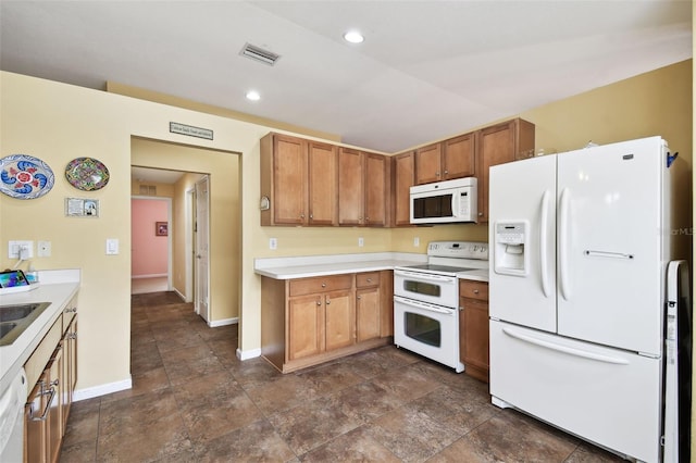 kitchen with dark tile patterned floors and white appliances