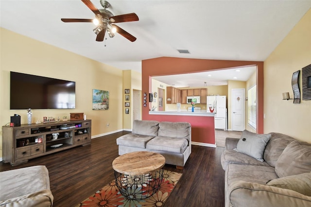 living room featuring ceiling fan, vaulted ceiling, and dark wood-type flooring