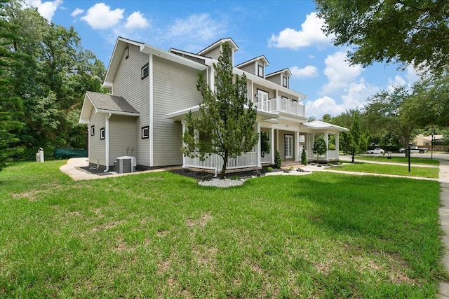 638 Limona Woods Dr, Brandon, FL 33510 - view of home's exterior featuring a balcony, central air condition unit, covered porch, and a yard