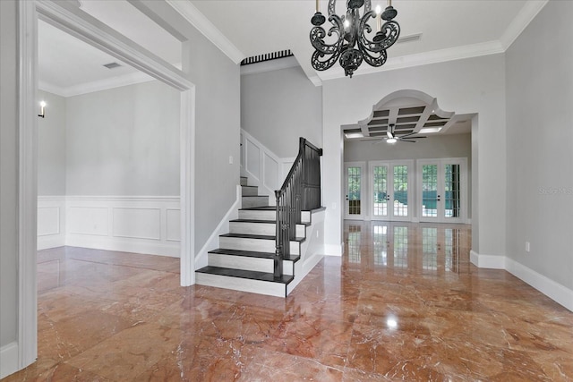 staircase with coffered ceiling, tile flooring, ceiling fan with notable chandelier, and crown molding