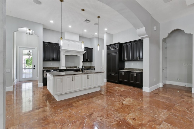 638 Limona Woods Dr, Brandon, FL 33510 - kitchen with baseboards, marble finish floor, dark countertops, arched walkways, and dark cabinets