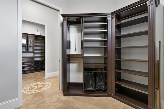 walk in closet featuring tile floors