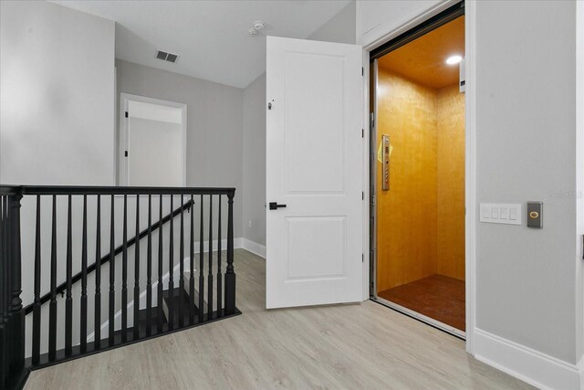 corridor featuring light hardwood / wood-style flooring