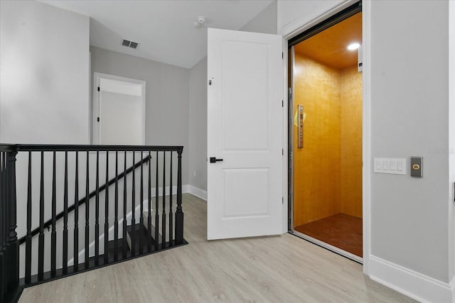 638 Limona Woods Dr, Brandon, FL 33510 - corridor with wood finished floors, an upstairs landing, baseboards, and visible vents