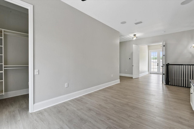 638 Limona Woods Dr, Brandon, FL 33510 - spare room with light wood finished floors, baseboards, visible vents, and french doors