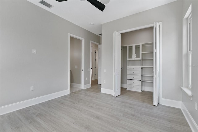 unfurnished bedroom featuring ceiling fan, a closet, and light wood-type flooring