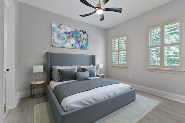 bedroom with ceiling fan and light wood-type flooring