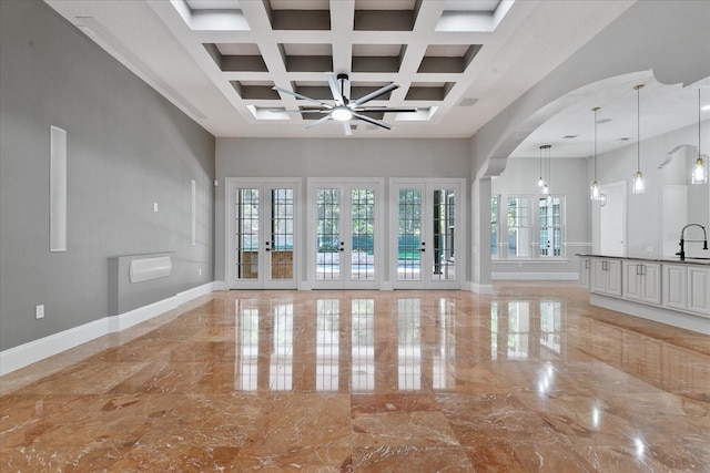 interior space featuring beamed ceiling, coffered ceiling, french doors, and light tile floors