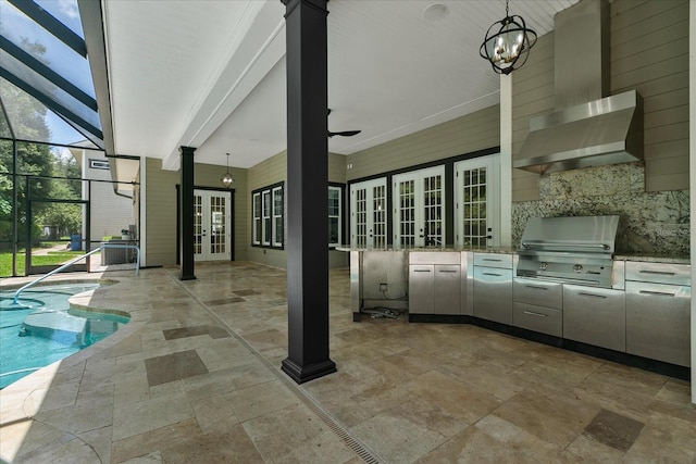 view of patio / terrace featuring a lanai, exterior kitchen, ceiling fan, area for grilling, and french doors