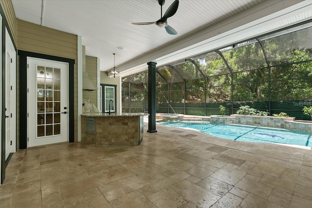 638 Limona Woods Dr, Brandon, FL 33510 - view of swimming pool featuring a sink, glass enclosure, an outdoor kitchen, a pool with connected hot tub, and a patio area