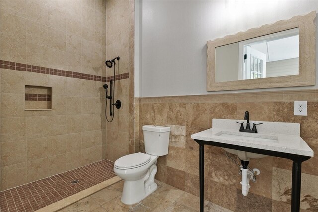 638 Limona Woods Dr, Brandon, FL 33510 - full bathroom featuring toilet, tile walls, a tile shower, and wainscoting