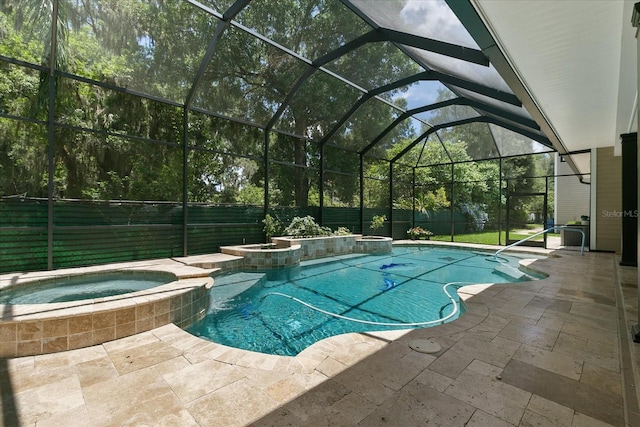 view of pool featuring an in ground hot tub, a patio, and a lanai