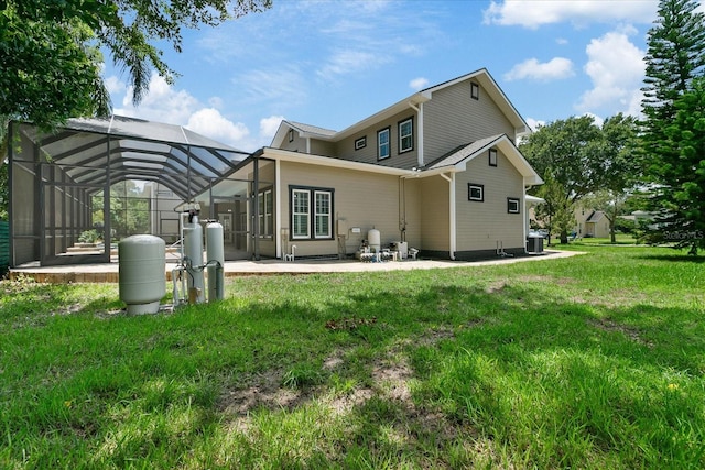 back of property featuring a lawn, central AC unit, a lanai, and a patio