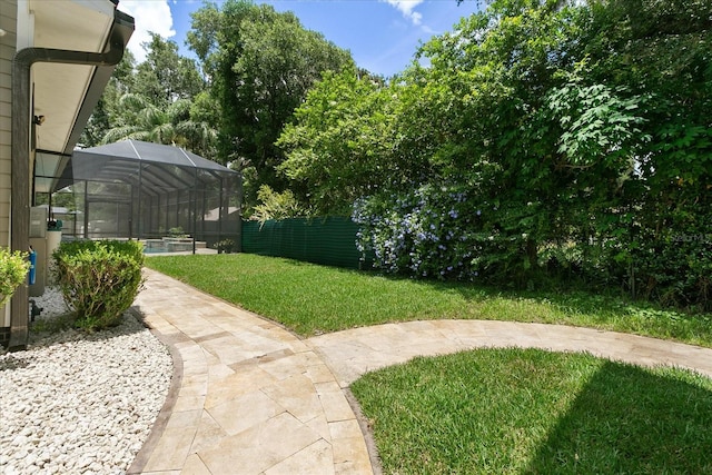 view of yard featuring a swimming pool and a lanai