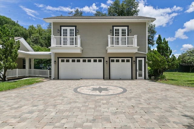 view of front facade featuring a garage and a balcony