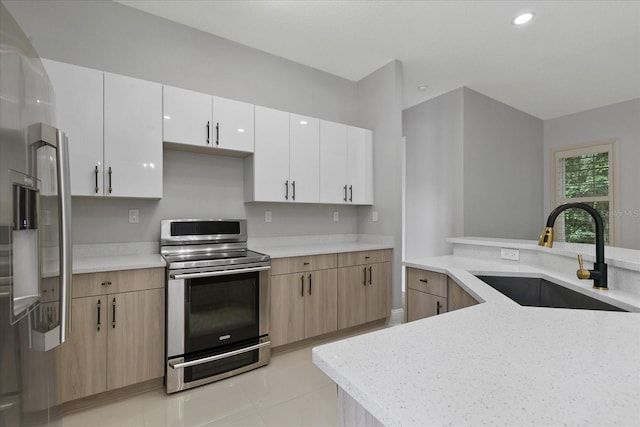 638 Limona Woods Dr, Brandon, FL 33510 - kitchen featuring white cabinetry, recessed lighting, a sink, light stone countertops, and appliances with stainless steel finishes