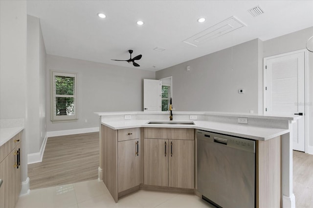 kitchen with ceiling fan, a kitchen island with sink, stainless steel dishwasher, sink, and light tile floors