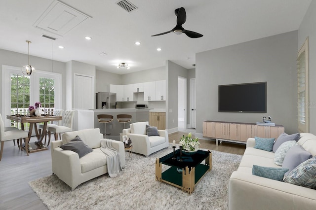 638 Limona Woods Dr, Brandon, FL 33510 - living room with attic access, light wood-style flooring, visible vents, ceiling fan, and recessed lighting