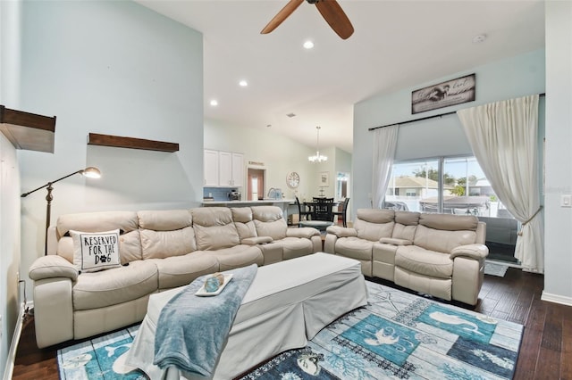 living room with ceiling fan with notable chandelier, dark wood-type flooring, and vaulted ceiling