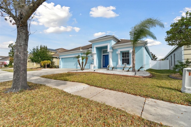 view of front facade with a garage and a front lawn