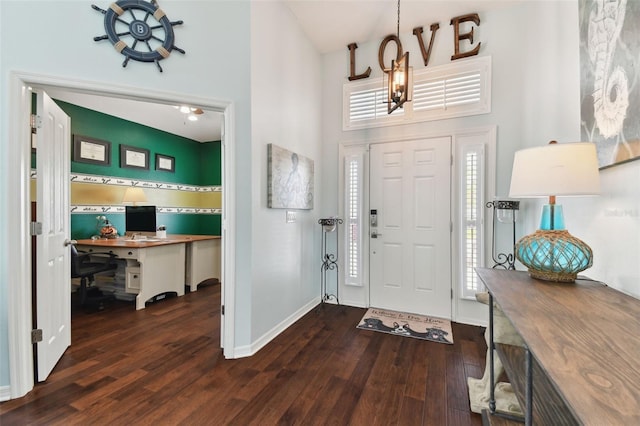 foyer with a high ceiling and dark hardwood / wood-style flooring