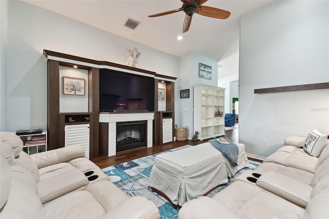 living room with dark wood-type flooring and ceiling fan