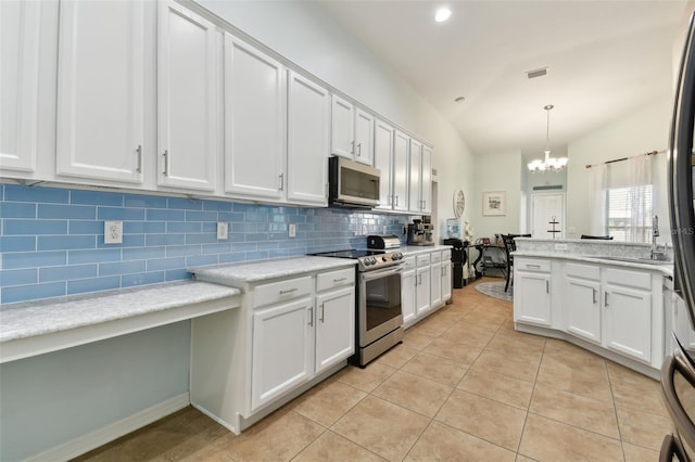 kitchen with pendant lighting, stainless steel appliances, a chandelier, and white cabinets