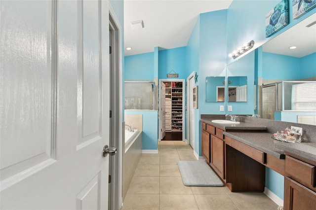 bathroom featuring plus walk in shower, tile patterned floors, and vanity