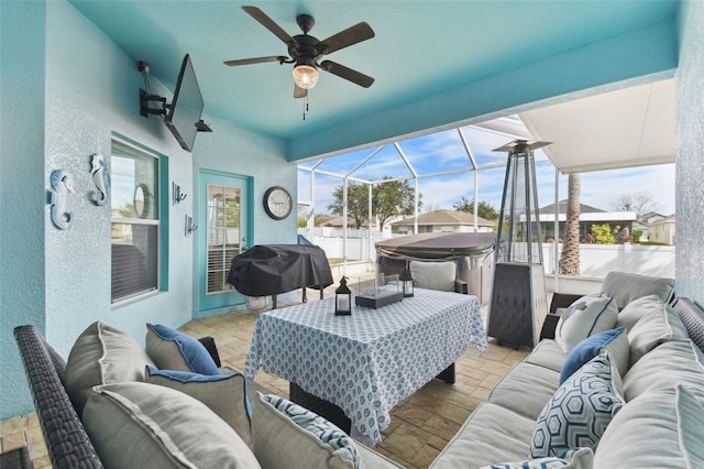 view of patio / terrace with ceiling fan, an outdoor living space, a lanai, and a grill