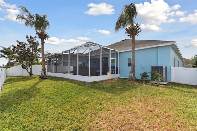 back of property featuring a lawn and a sunroom