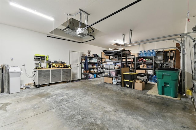 garage with a garage door opener and a workshop area