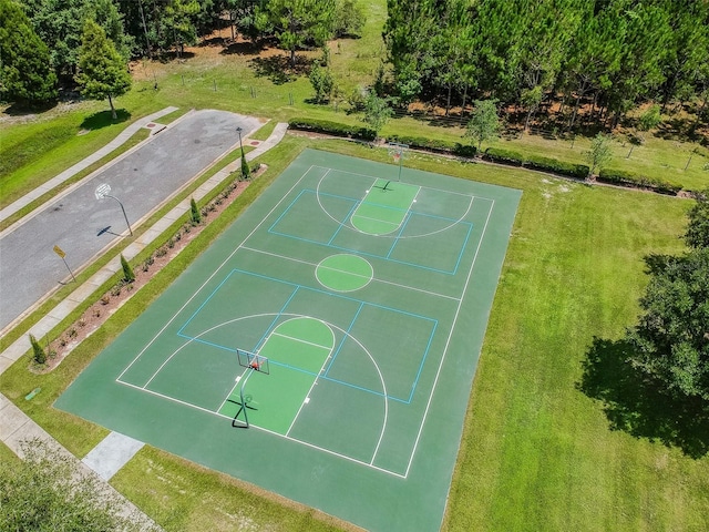 view of sport court featuring a lawn