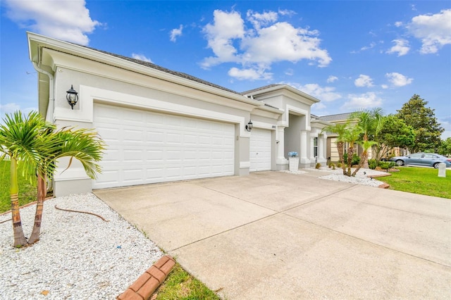 6843 Boulder Run Loop, Wesley Chapel, FL 33545 - view of front of house featuring driveway, a garage, and stucco siding