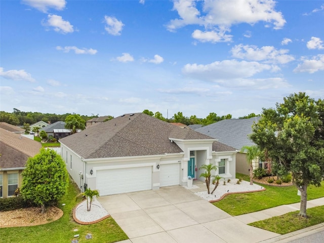 6843 Boulder Run Loop, Wesley Chapel, FL 33545 - ranch-style home with an attached garage, a shingled roof, driveway, stucco siding, and a front yard