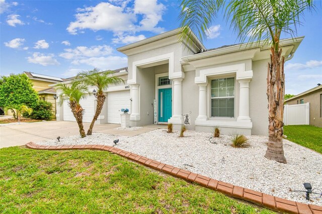 6843 Boulder Run Loop, Wesley Chapel, FL 33545 - view of front of home with an attached garage, driveway, and stucco siding