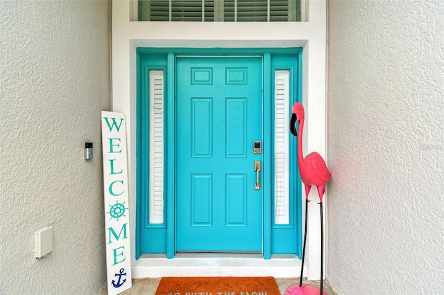 6843 Boulder Run Loop, Wesley Chapel, FL 33545 - doorway to property featuring stucco siding