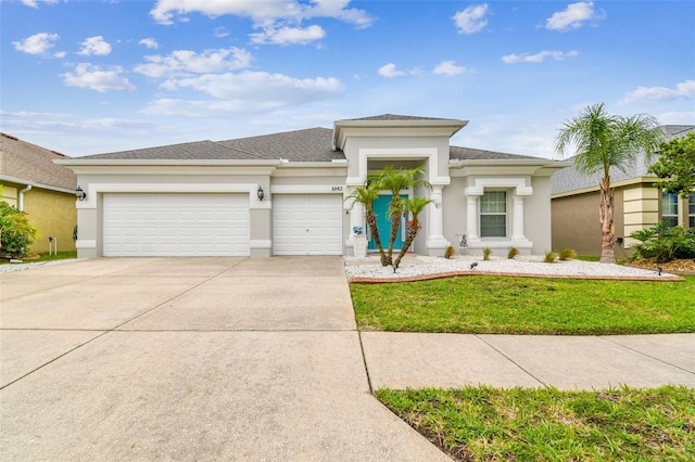 6843 Boulder Run Loop, Wesley Chapel, FL 33545 - prairie-style home with an attached garage, stucco siding, concrete driveway, and a front yard