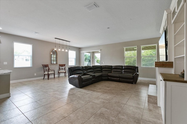 living room featuring light tile patterned floors and a textured ceiling