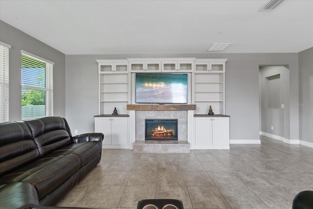 tiled living room featuring a textured ceiling