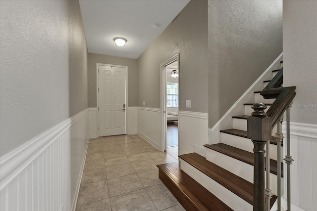 tiled entryway with a textured ceiling