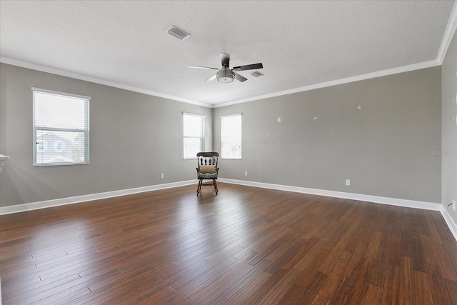 unfurnished room featuring a textured ceiling, ceiling fan, crown molding, and dark wood-type flooring