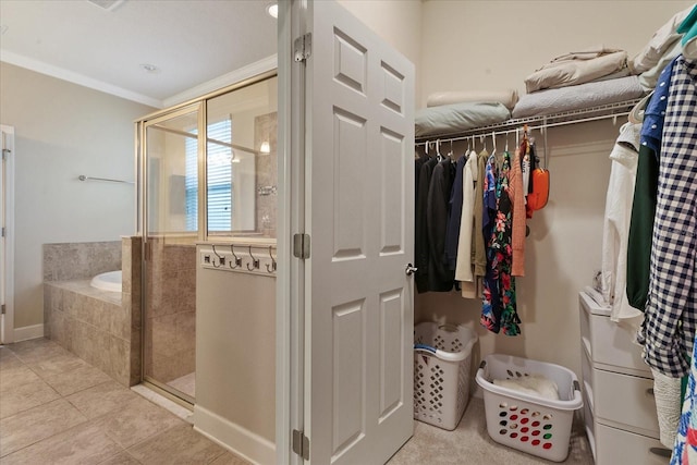 bathroom featuring tile patterned floors, crown molding, and plus walk in shower