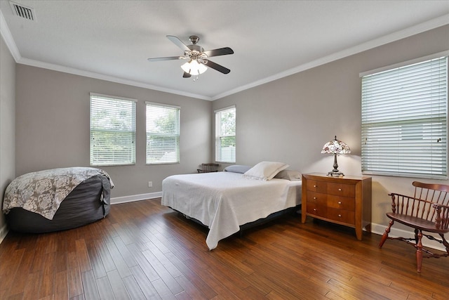 bedroom featuring dark hardwood / wood-style flooring, ceiling fan, and crown molding