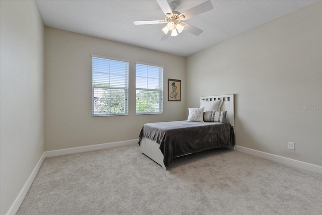 bedroom with ceiling fan and light colored carpet